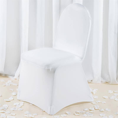 White chair cover on a plain backdrop with rose petals scattered around.