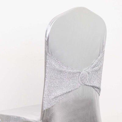 Silver chair cover with a decorative glitter bow detail.