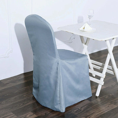 Elegant blue chair cover draped over a chair next to a white table.