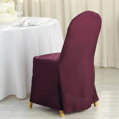 Burgundy chair cover on a dining chair in a banquet setting.