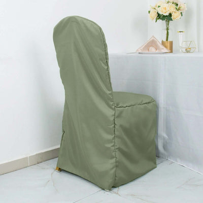 Green chair cover on a dining chair by a table with flowers.