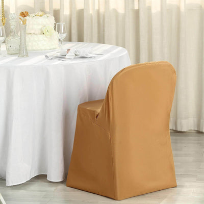 Elegant gold chair cover on a dining chair by a table set for an event.