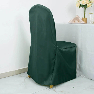 Green chair cover draped over a chair in a styled setting.
