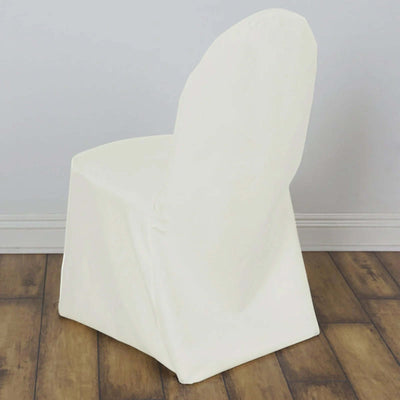 White chair cover on a wooden floor, showcasing elegant draping.