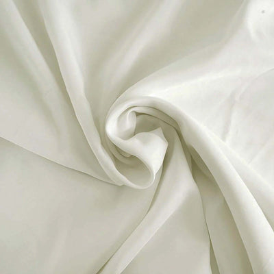 Soft, flowing ivory fabric in a smooth, elegant swirl.