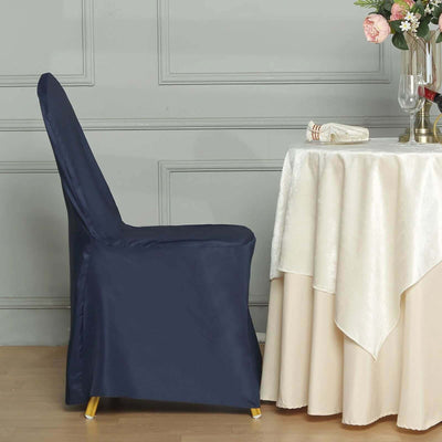 Elegant navy chair cover draped over a banquet chair beside a table.
