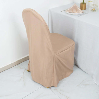 Beige chair cover draped over a dining chair in a stylish setting.