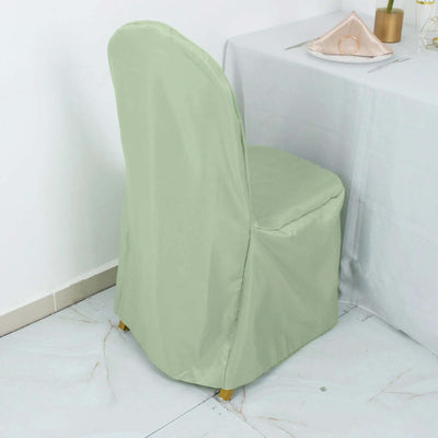 Mint green chair cover on a dining chair next to a table setting.