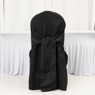 Black chair cover with bow, styled for events.
