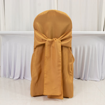 Gold chair cover with a bow, perfect for elegant events.