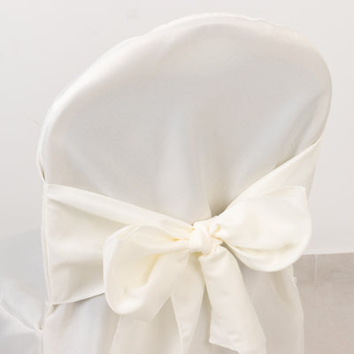 White chair cover with elegant bow detail.