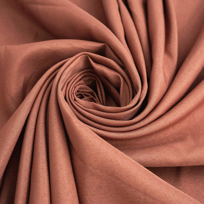 Brown fabric in a rolled spiral pattern showcasing its texture and drape.