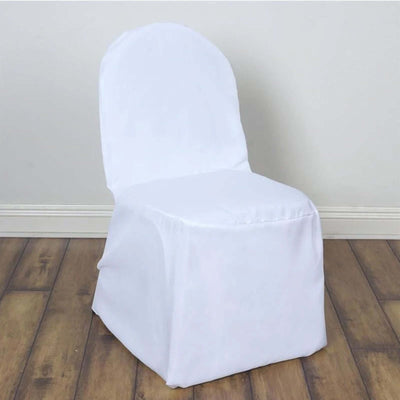 White chair cover draped over a chair on a wooden floor.