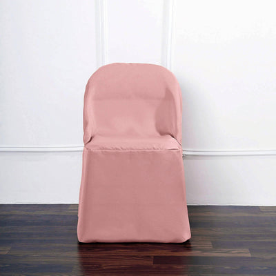Pink chair cover on a wooden floor against a white wall.