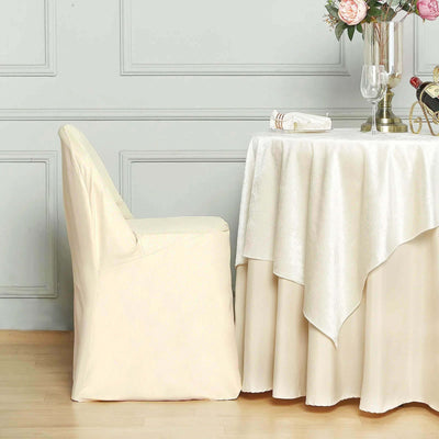 Cream chair cover on a dining chair beside an elegantly set table.