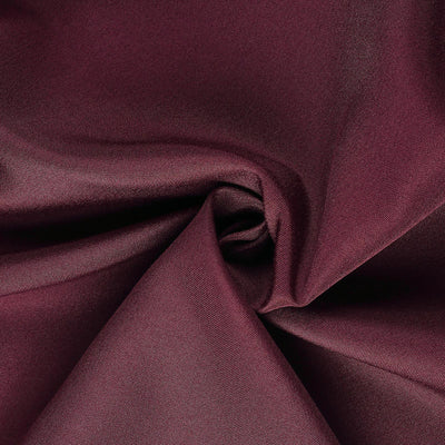 Burgundy fabric texture with smooth draping and rich color.
