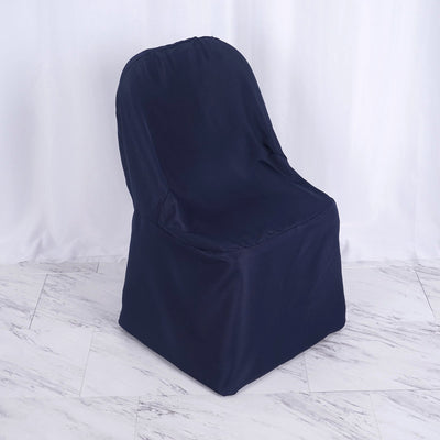 Navy blue slipcovered chair on a plain background