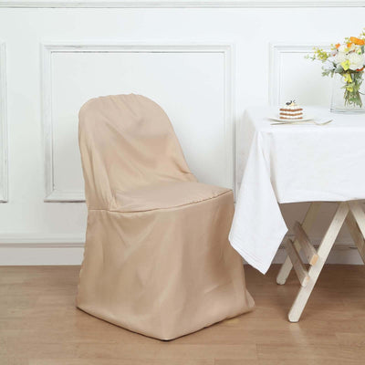 Beige chair cover draped over a chair near a table with flowers and dessert.