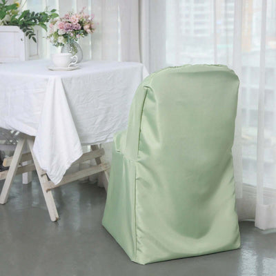 Green chair cover in a bright dining space with a table and floral arrangement.