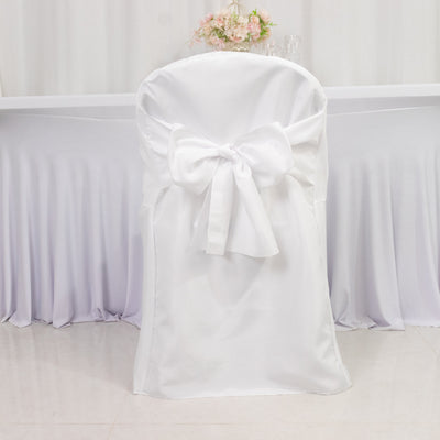 White chair cover with a large bow, perfect for weddings and events.