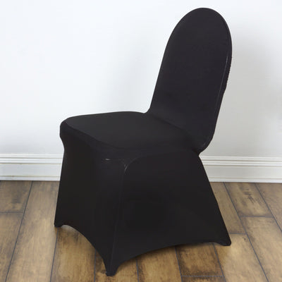 Black modern chair with a sleek design on a plain backdrop.