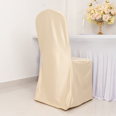 Beige chair cover draped over a dining chair in a decorated setting.