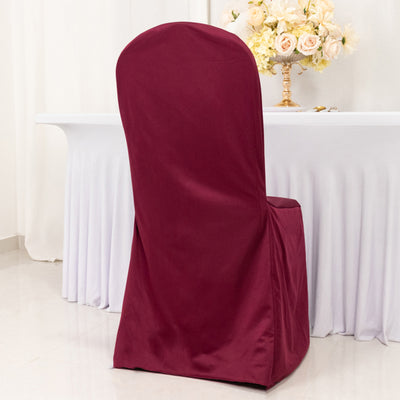 Burgundy chair cover draped over a dining chair in an elegant setting.