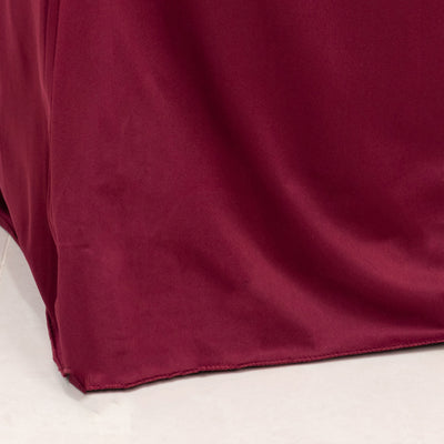 Burgundy tablecloth draping elegantly over a table edge.