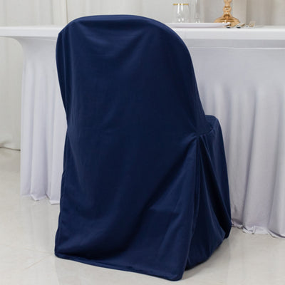 Navy blue chair cover on a dining chair against a neutral backdrop.