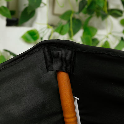 Close-up of the interior stitching and handle of a black fabric umbrella.