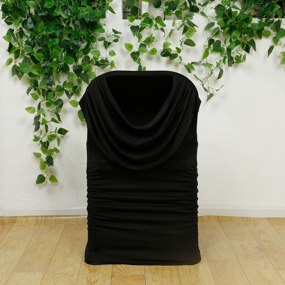 Black draped fabric storage basket with gathered sides.