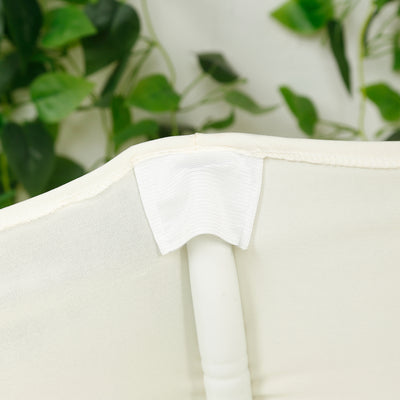 Close-up of a white fabric chair cover attachment detail.