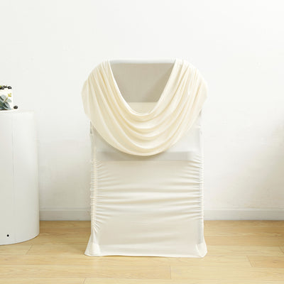 Cream draped chair cover on a white backdrop
