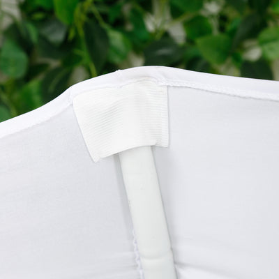 White fabric with a plastic pole attachment for a tent or canopy.