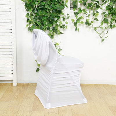 White chair cover draped elegantly over a chair against a leafy backdrop.