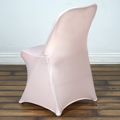 Pink chair cover on a dining chair, showcasing a sleek design and fabric texture.