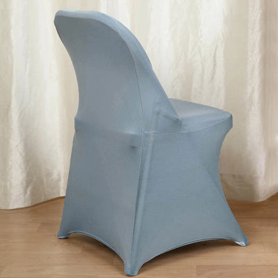 Blue stretch chair cover on a wooden floor against a light backdrop.