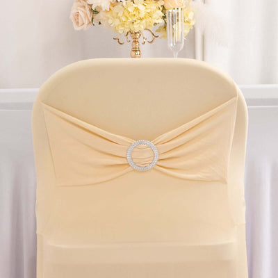 Elegant peach chair cover with rhinestone detail on a plain backdrop.