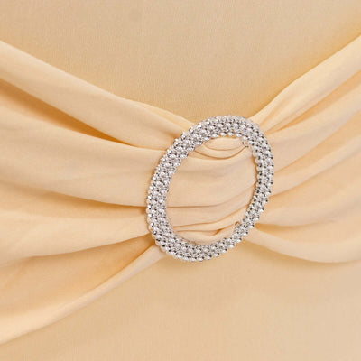 Beige fabric with a sparkling rhinestone circular embellishment detail.