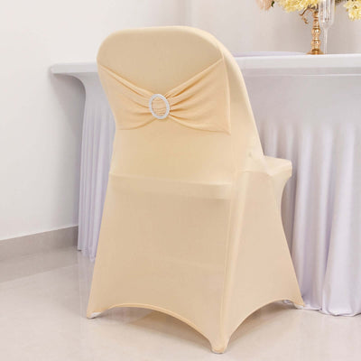 Elegant beige chair cover with decorative back bow for event styling.