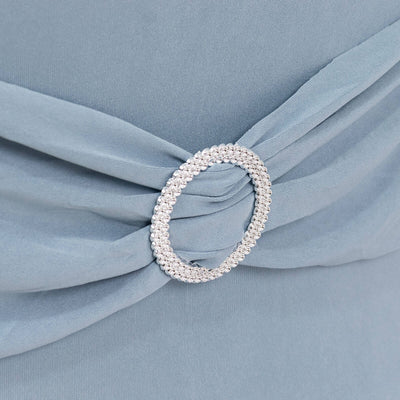 Elegant blue dress detail featuring a rhinestone buckle.