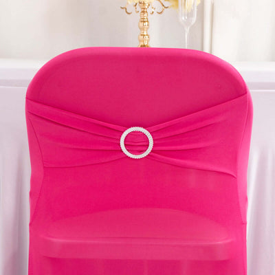 Pink chair cover with decorative pearl ring detail.