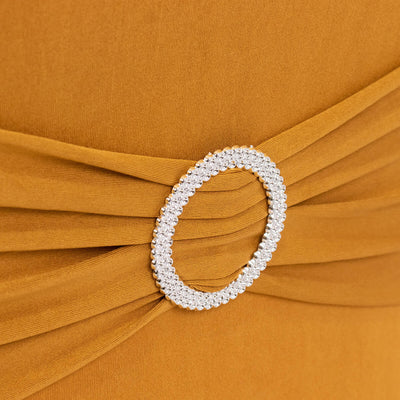 Elegant mustard dress detail with crystal-embellished belt buckle.