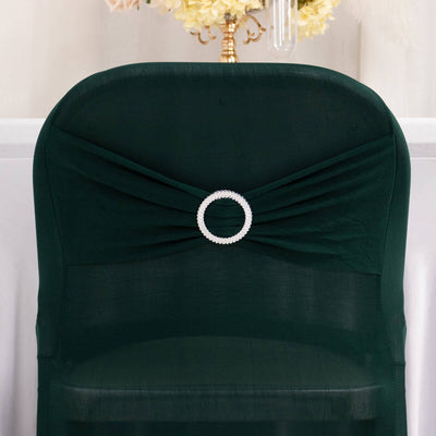 Green chair cover with pearl accent detail.