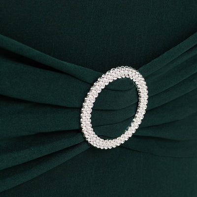 Emerald green dress detail with sparkling circular embellishment.
