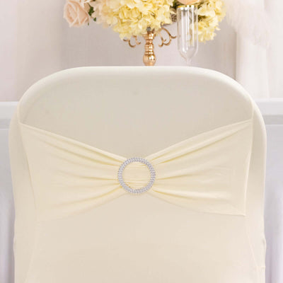 Elegant cream chair cover with jeweled accent for weddings and events.