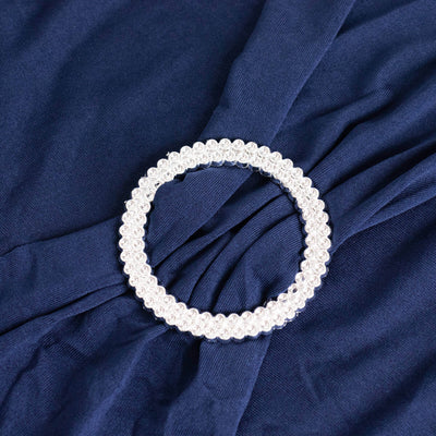 Silver beaded circle brooch on navy fabric