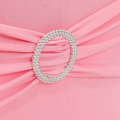 Close-up of pink fabric with a decorative silver ring detail.
