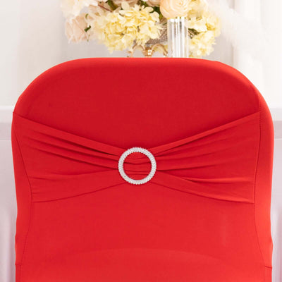Red chair cover with jeweled embellishment for elegant events.