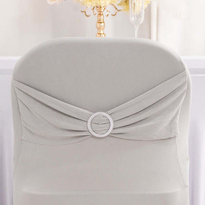 Elegant gray chair cover with a rhinestone embellishment.